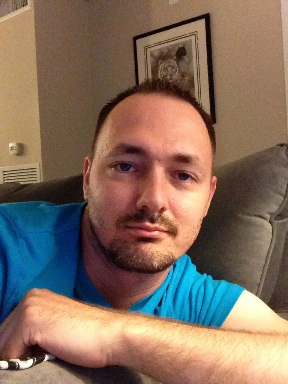 Darrell relaxing on the couch at home